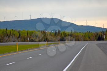 View of the Trans-Canadian Highway with electric wind mill towers in the background.