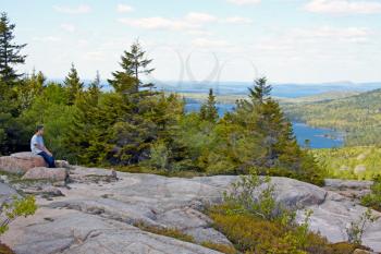 Boy hiker admiring the scenic view of Acadia National Park, Maine.