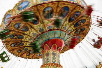 Children riding a colorful merry-go-round at the county fair.