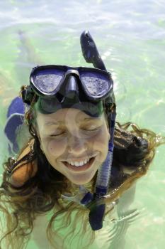 Isla Mujeres, Mexico- November 4, 2016: Happy unknown girl snorkeling on a coral reef.