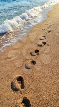 Footprints on the sandy beach, nature background