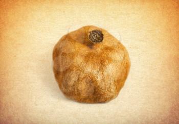 Royalty Free Photo of a Dry Pomegranate on a Vintage Background