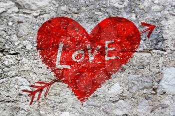 Drawing of abstract heart pierced by an arrow with word Love on grunge stone wall texture