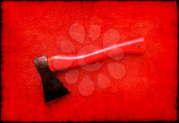 Red axe on red board background