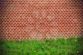 Brick red wall and green grass vintage background