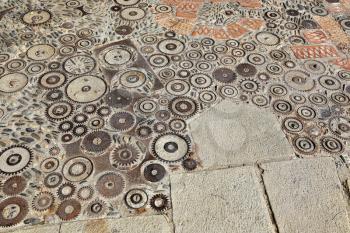 Unusual floor with pattern from pebbles, brick and rusty metal details in the park Montjuic, Barcelona, Catalonia, Spain