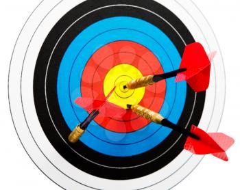 Royalty Free Photo of a Dartboard with Red Darts
