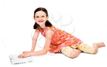 Royalty Free Photo of a Young Girl Sitting on the Floor Using her Laptop