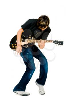 Royalty Free Photo of a Young Man Playing a Guitar