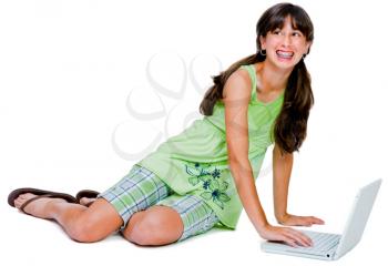 Royalty Free Photo of a Teenage Girl Wearing Braces Sitting on the Floor Using her Laptop