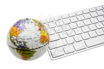 Royalty Free Photo of a Globe Next to a Computer Keyboard