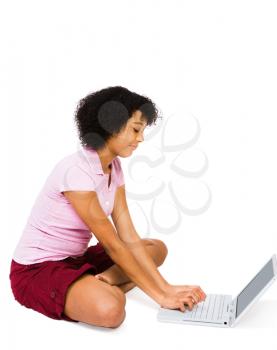 Royalty Free Photo of a Teenage Girl Sitting on the Floor Using a Laptop