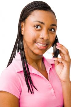 African teenage girl talking on a mobile phone isolated over white