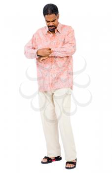 Mature man buttoning his shirt isolated over white
