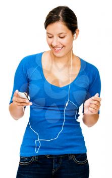 Caucasian woman listening to music on an mp3 player isolated over white