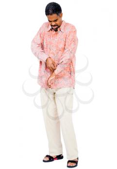 Man buttoning his shirt isolated over white