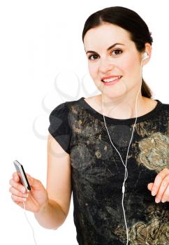 Fashion model listening to music on MP3 player isolated over white