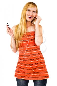 Caucasian woman listening to music on MP3 player isolated over white
