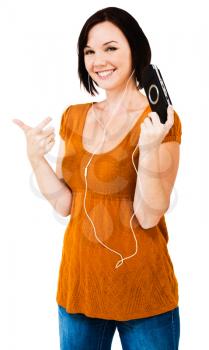Caucasian woman listening to music on an media player isolated over white