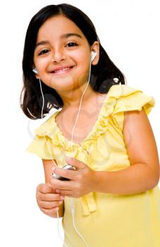 Portrait of a girl listening to music on a MP3 player isolated over white