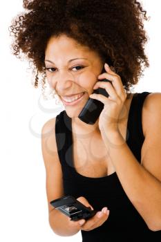 Happy woman talking on a mobile phone isolated over white