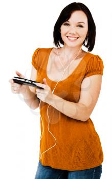 Beautiful woman listening to music on an media player isolated over white