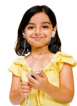 Mixedrace girl listening to music on a MP3 player isolated over white