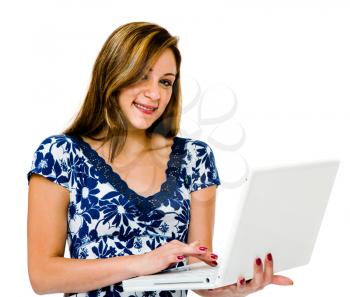 Portrait of a teenage girl using a laptop and smiling isolated over white