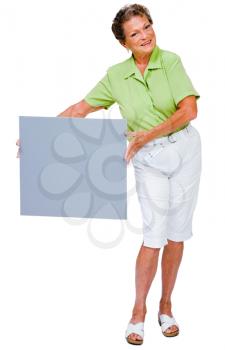 Smiling mature woman showing a placard isolated over white