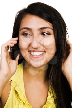 Middle Eastern woman talking on a mobile phone isolated over white