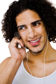 Fashion model listening to music on a MP3 player isolated over white