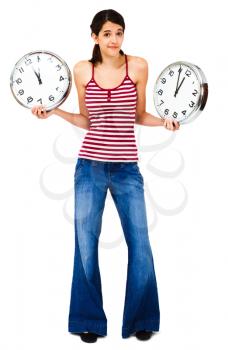 Woman holding clocks and posing isolated over white