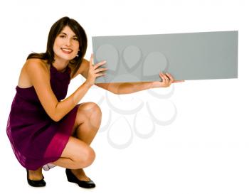 Happy woman showing an empty placard isolated over white