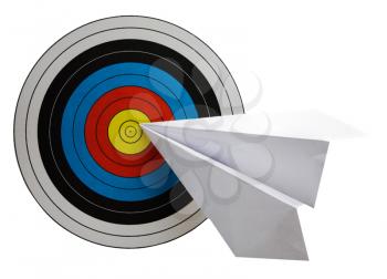Dartboard and a paper airplane isolated over white