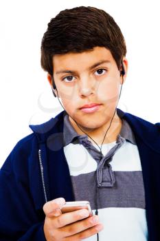 Boy listening to music on an MP3 player isolated over white