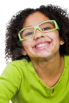 Girl wearing eyeglasses and smiling isolated over white