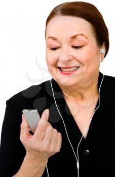 Close-up of a woman listening to MP3 player isolated over white