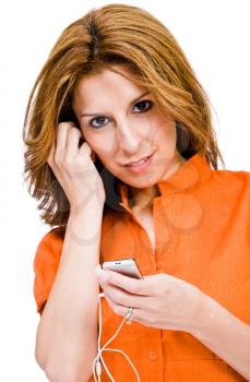 Latin American woman listening to music on MP3 player isolated over white