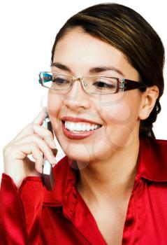 Woman talking on a mobile phone and smiling isolated over white