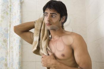 Close-up of a man wiping himself with a towel