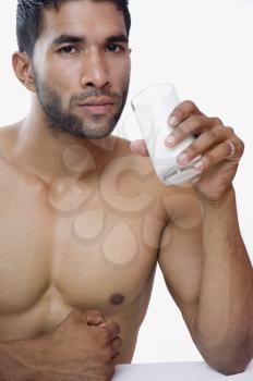 Portrait of a macho man drinking milk