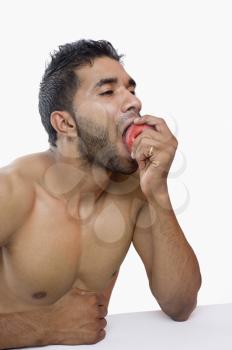 Close-up of a macho man eating apple