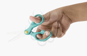 Close-up of a woman's hand holding scissors