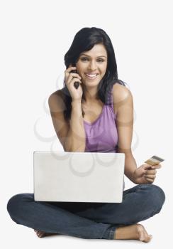 Woman shopping online and talking on a mobile phone