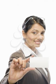 Portrait of a businesswoman showing a business card against a white background