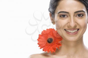 Portrait of a beautiful Indian fashion model with a flower