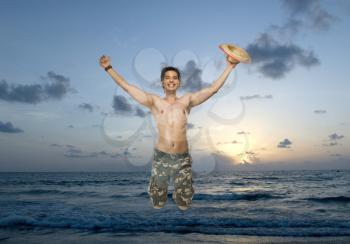 Portrait of a young man jumping with joy