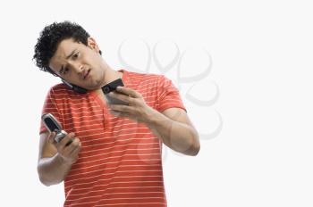 Man using multiple mobile phones