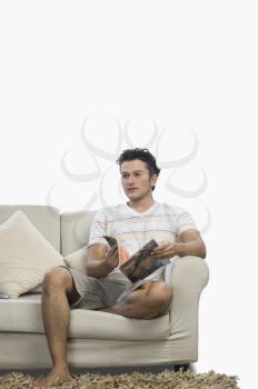 Man holding a magazine on a couch