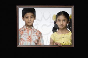 Portrait of a girl and a boy in a picture frame
